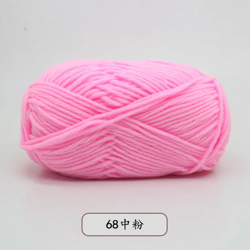 A ball of bright pink 4-ply milk cotton yarn for knitting and crochet.