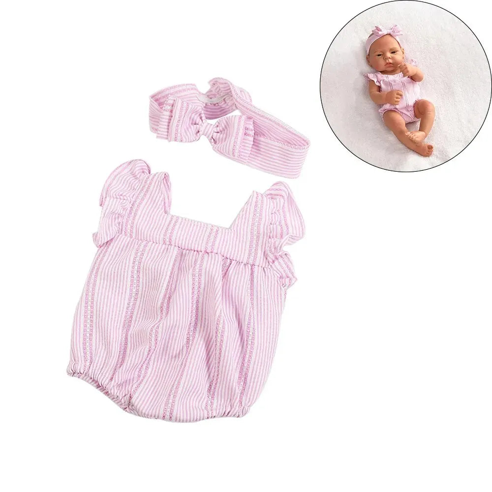 A pink striped outfit set for a baby doll includes a top and a bow accessory, shown next to a doll.