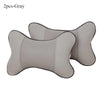 Gray leather knitted car neck pillows with a perforated texture shown from the side.