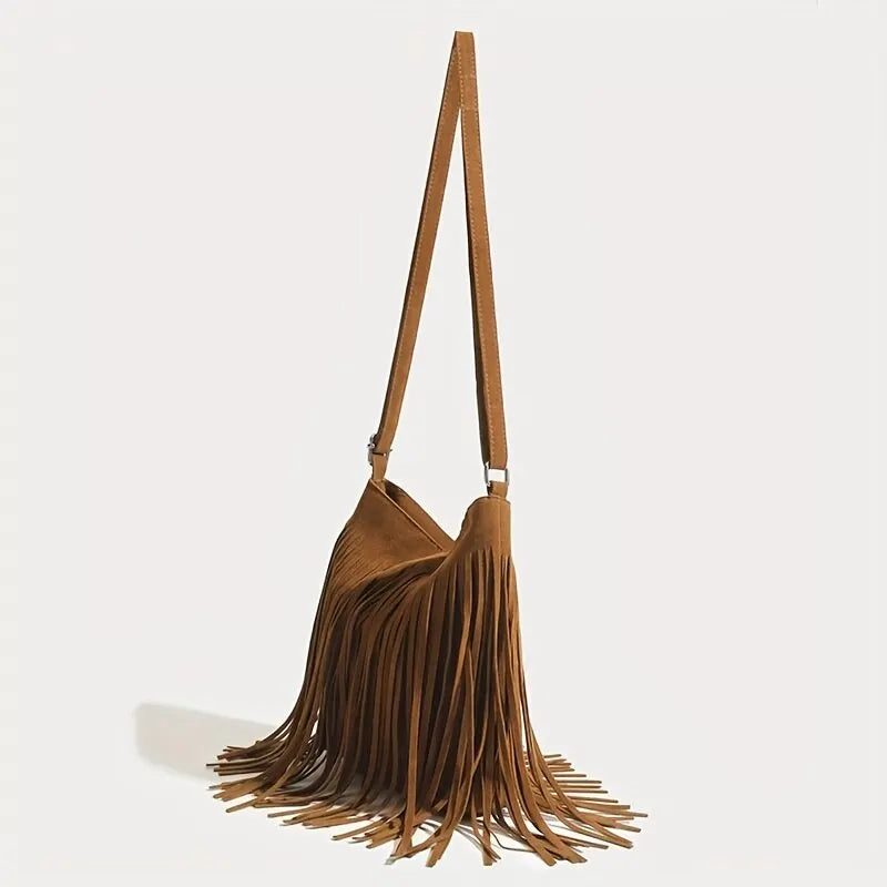 A brown bohemian fringe shoulder bag with a long strap is displayed against a light background.