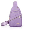 A purple quilted crossbody sling bag with a zipper and strap is shown against a white background.