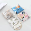 A collection of fabric cosmetic storage pouches featuring various patterns including cats, natural leaves, and floral designs