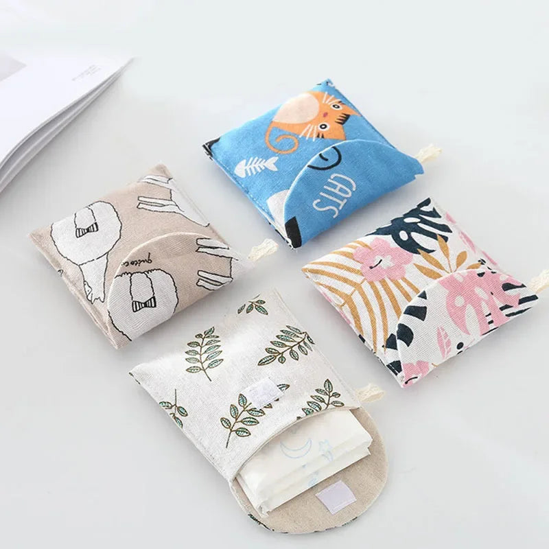 A collection of fabric cosmetic storage pouches featuring various patterns including cats, natural leaves, and floral designs