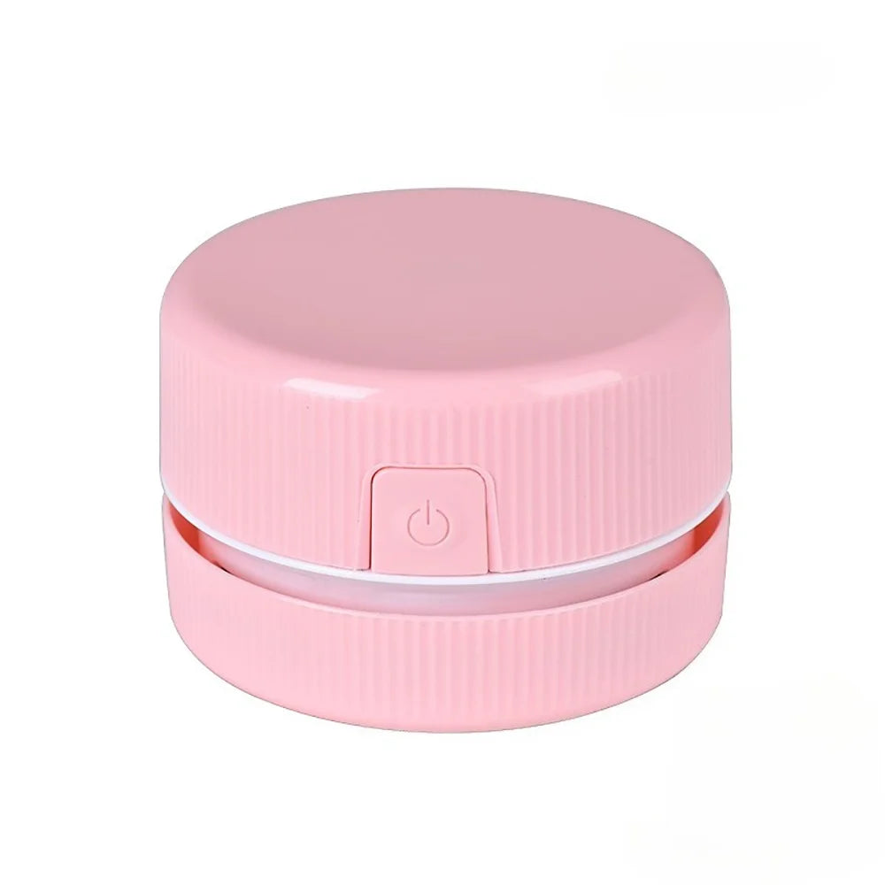 Pinkes Mini-Schreibtischstaubsauger mit runder Klappe und Einschaltknopf