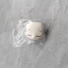 A white articulated ball-jointed doll figurine is sealed in a clear plastic blind box bag.