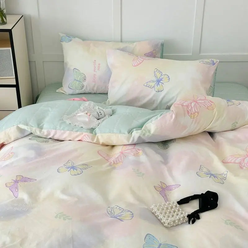 Pink floral bedding set featuring a duvet cover and pillows with butterfly patterns.