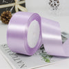 A roll of light purple satin ribbon used for gift wrapping or DIY crafts.