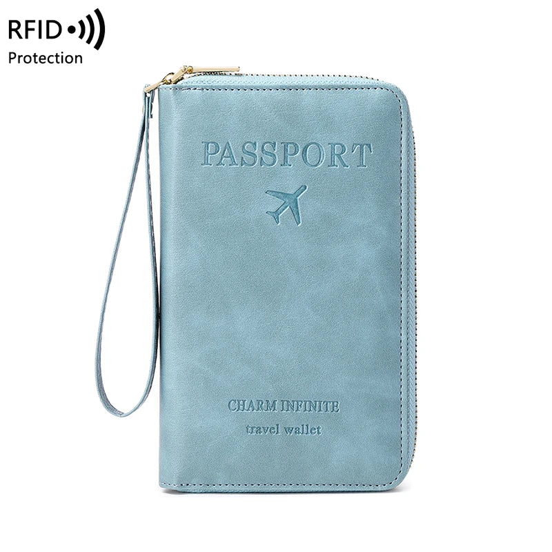 A light blue passport wallet with a zipper and wrist strap, featuring the Charm Infinite travel wallet design.