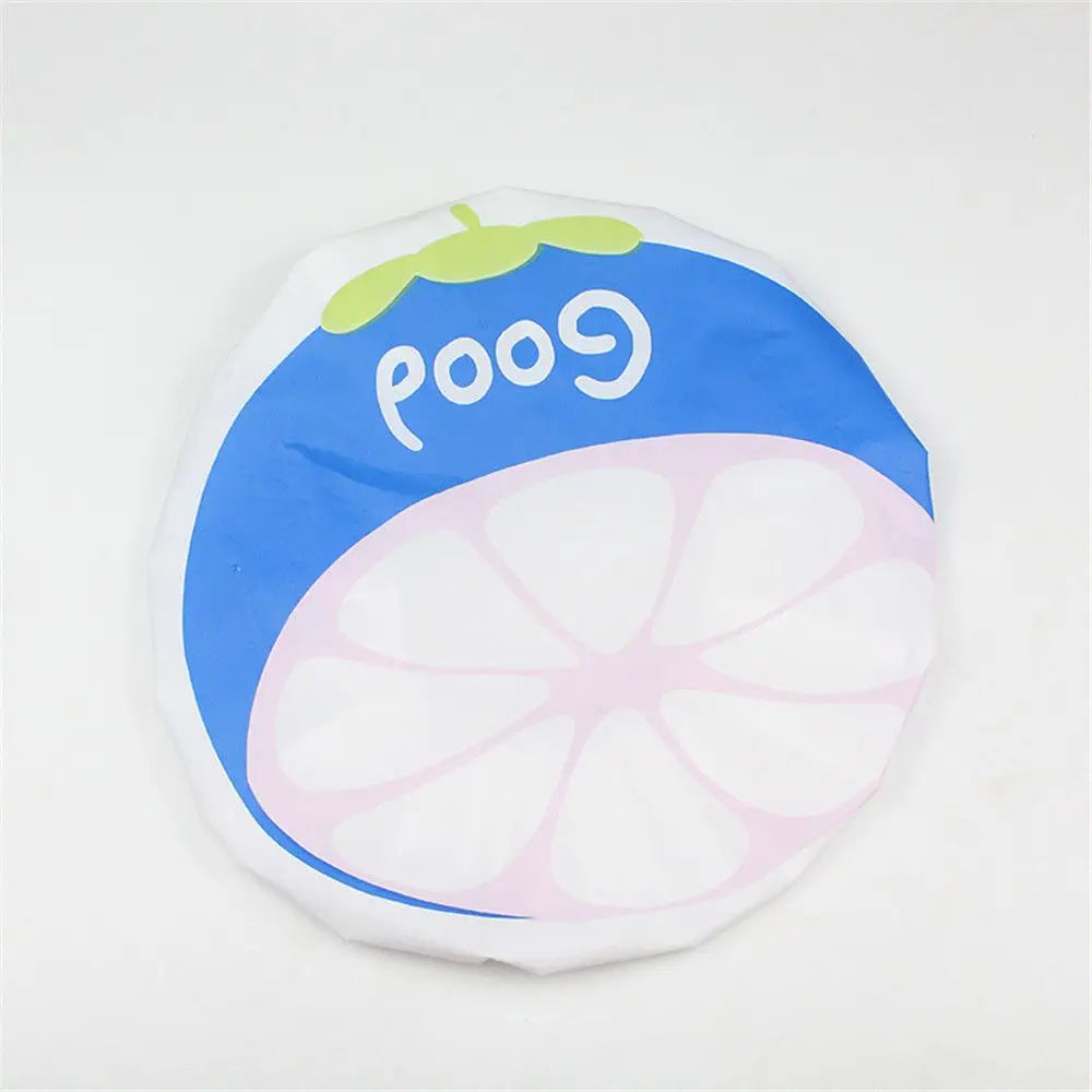 A waterproof shower cap featuring a design of a slice of lime and the word Good