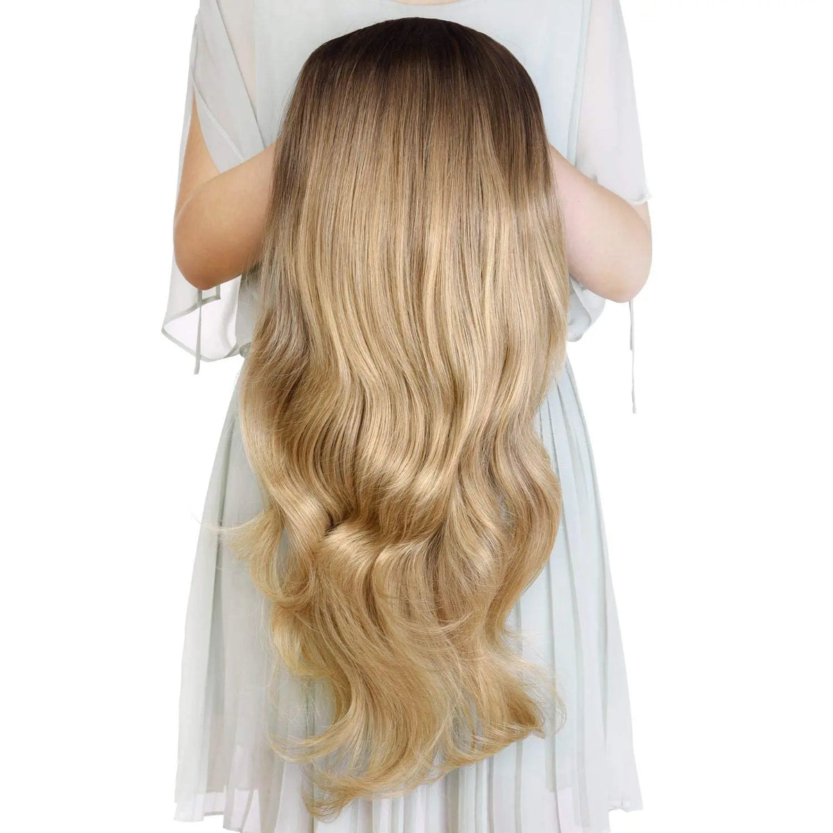 A long, wavy blonde wig is shown draped over a person's shoulders.