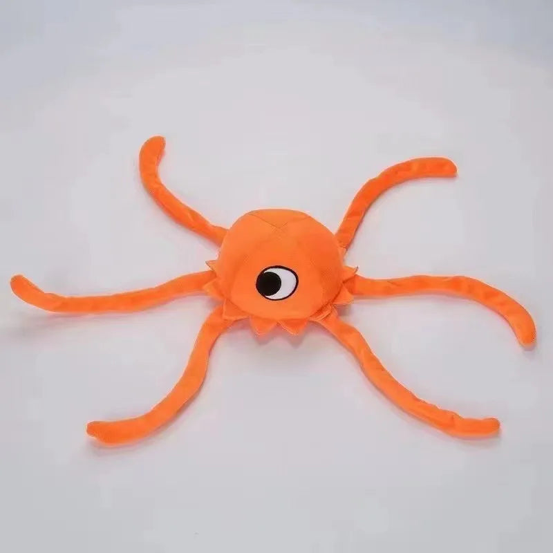 An orange plush toy shaped like a starfish with eight arms and a central eye.