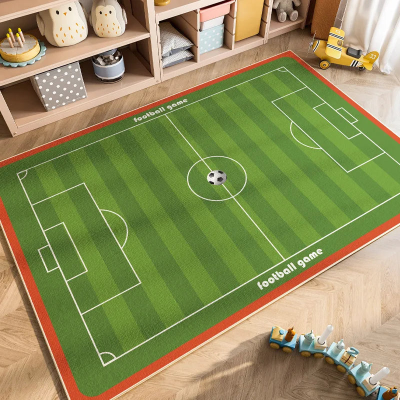 A green football game mat with white lines and a soccer ball is laid out on a wooden shelf.