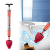 A red high-pressure toilet plunger with a pneumatic pump is shown being used in a toilet bowl.