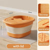 An orange and white foldable foot bath tub with a lid shown on a wooden floor.