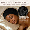 A woman is wearing a black silk bonnet, highlighting its serrated adjustable buckle and soft fabric.