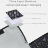 A three-layer waterproof diaper changing pad with a black and white patterned cover shown next to the gray fabric.