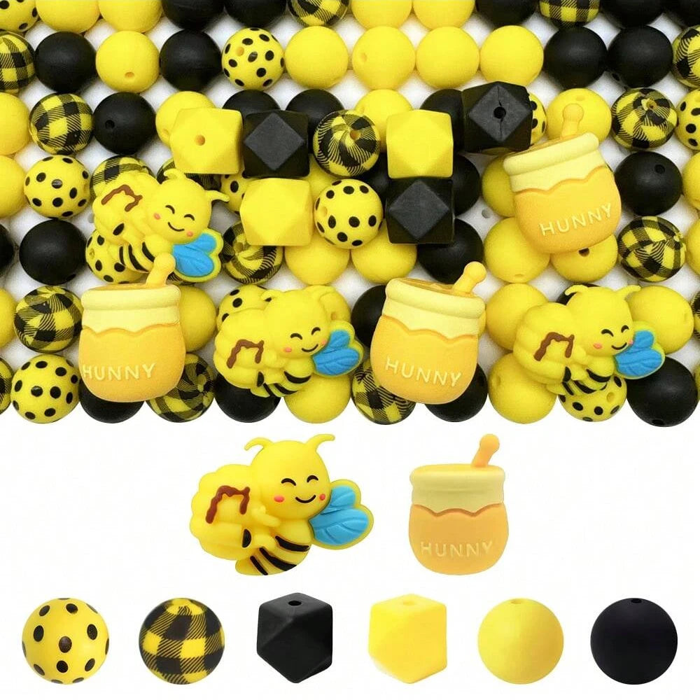 A collection of yellow and black silicone beads shaped like bees for jewelry making and DIY crafts.