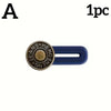 A single adjustable metal jeans button extender in gold and blue.