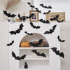 Black bat wall stickers with LED lights decorating a white shelf display.