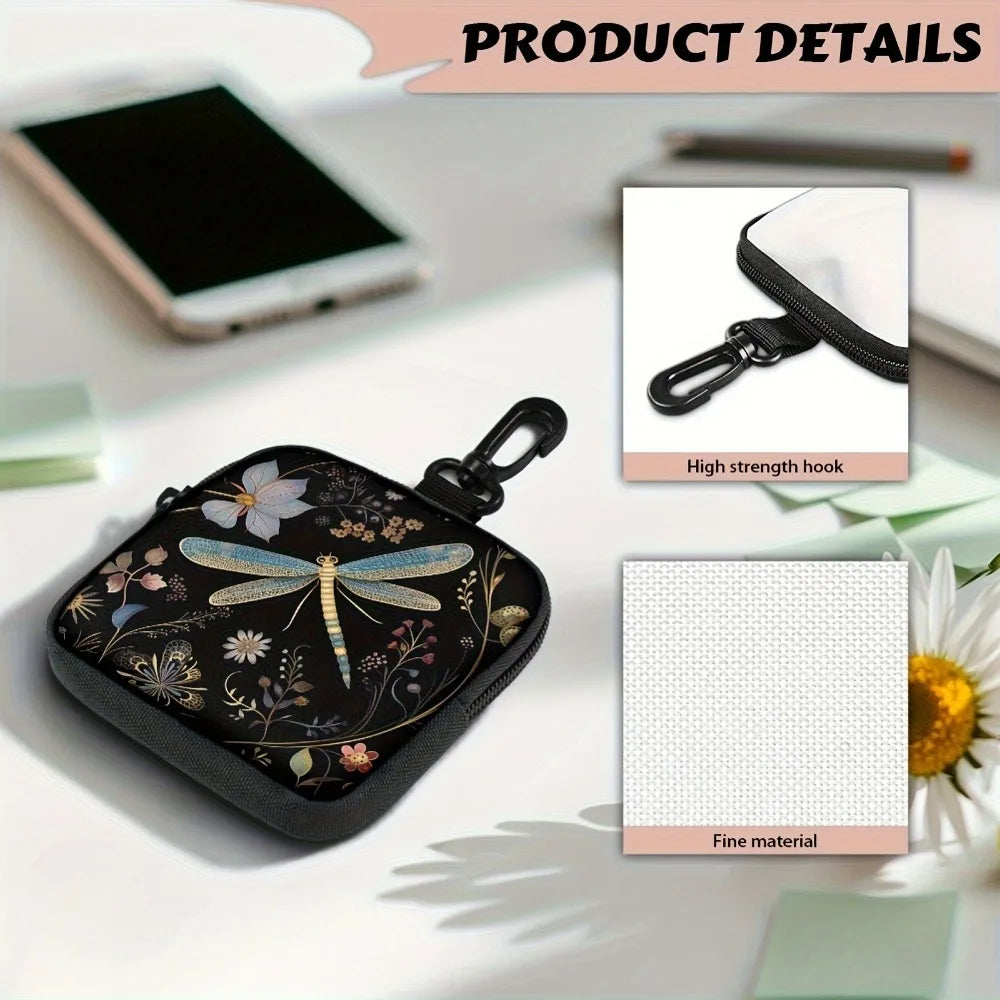 A black mini coin purse with a floral design and a strong hook is shown on a white surface.
