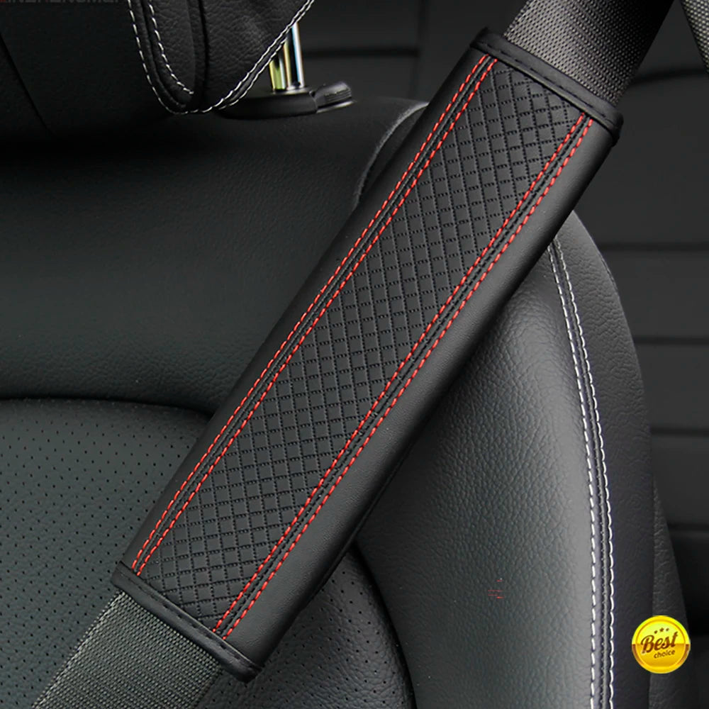 Close-up of a black PU leather embossed seat belt shoulder cushion with red stitching on a vehicle seat.