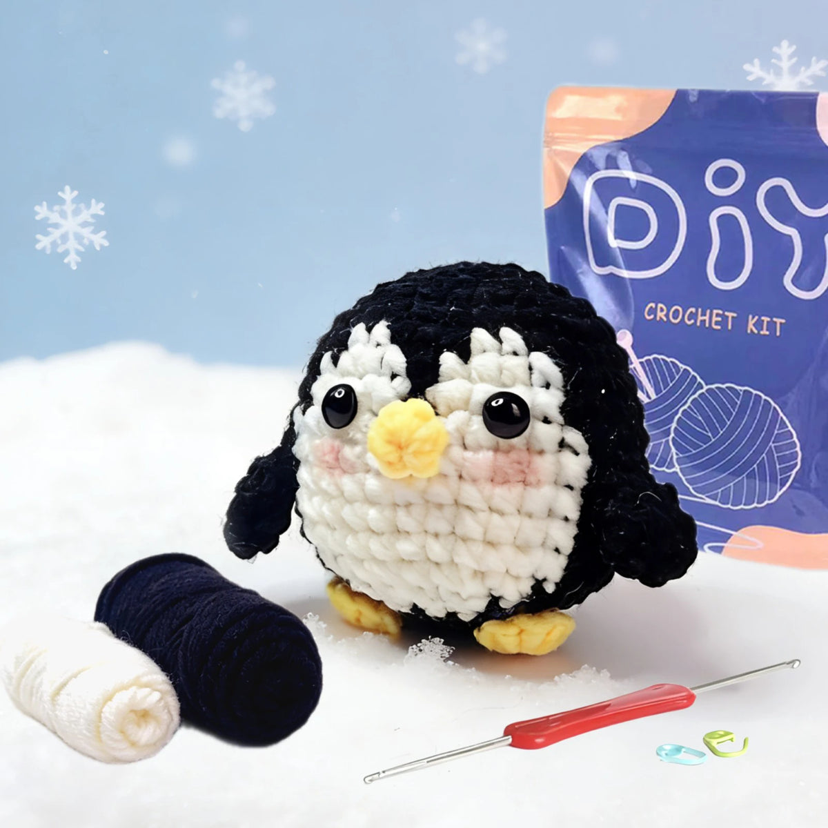 A black and white crocheted owl figure is shown next to a skein of yarn and a crochet hook.