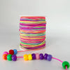 A spool of brightly colored rainbow elastic cord, with a length of the same cord stretched out.