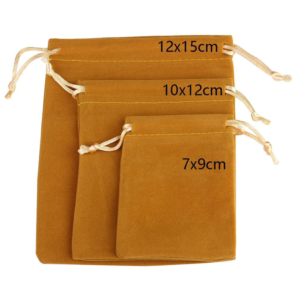 Three velvet drawstring jewelry pouches in shades of brown and orange with different sizes