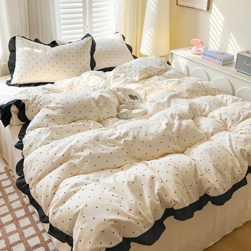 French style polka dot bedding set featuring a duvet cover and pillowcases in cream and black.