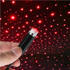 A hand holds a portable LED projection lamp with a flexible neck, illuminating a dark background with red stars.