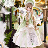 A beautiful 1/6 BJD doll with long blonde hair and a white dress in mint green and white, displayed in a decorative setting.