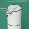 A white touchless automatic soap dispenser with a green accent, shown standing upright.