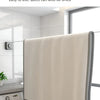 A beige retractable clothesline is shown hanging in a modern bathroom, next to a washing machine.