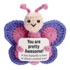 Handcrafted crocheted plush butterfly ornament with pink and purple wings and a smiling face