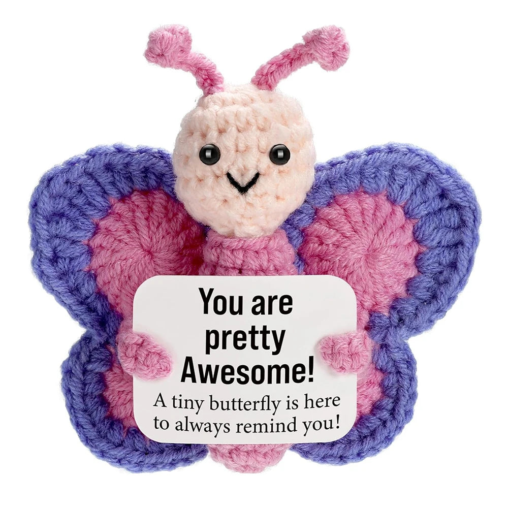 Handcrafted crocheted plush butterfly ornament with pink and purple wings and a smiling face