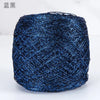 A ball of metallic blue silk crochet yarn with a shimmering texture for knitting and macrame.