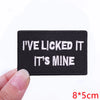Black embroidered iron-on letter patch with white text that reads I've licked it it's mine