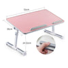 Pink adjustable foldable laptop desk with a light gray surface and metal supports.