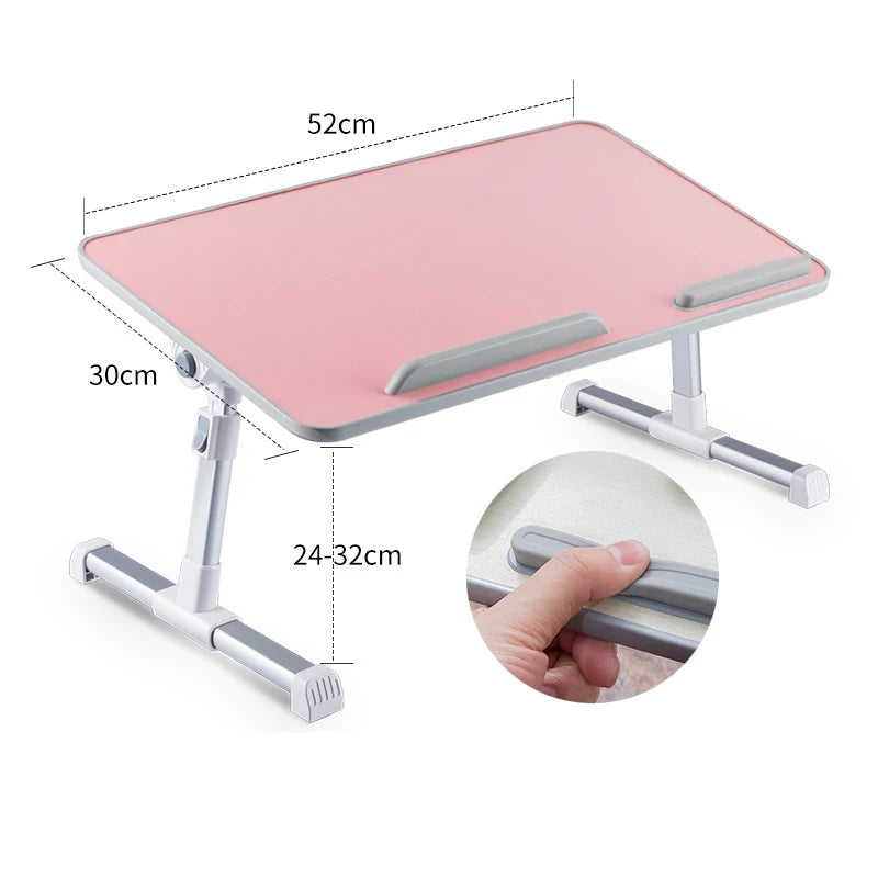 Pink adjustable foldable laptop desk with a light gray surface and metal supports.