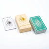 A box of The Classic Tarot deck with a guidebook and a stack of green tarot cards.