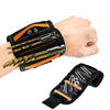 A hand is holding a black magnetic wrist strap with multiple tools attached, showing its grip and design.