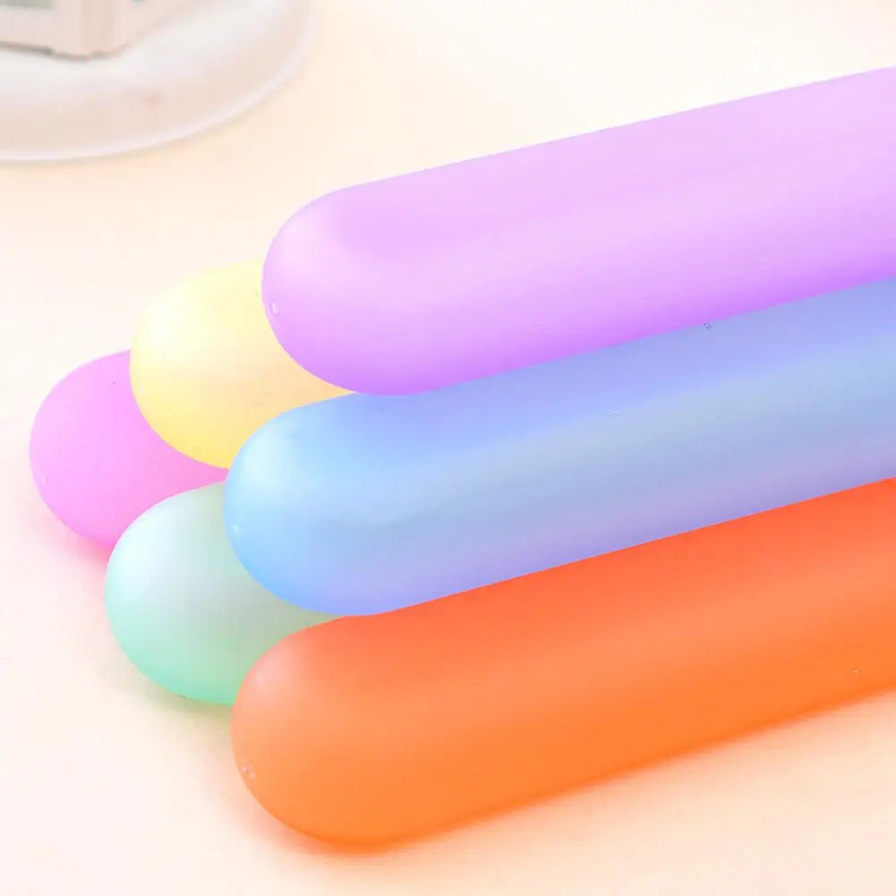A stack of colorful, translucent silicone tubes or covers for a portable toothbrush travel case.