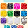 A display of various colorful plastic balls including orange, black, pink, red, yellow, green, blue, purple, white, and trans