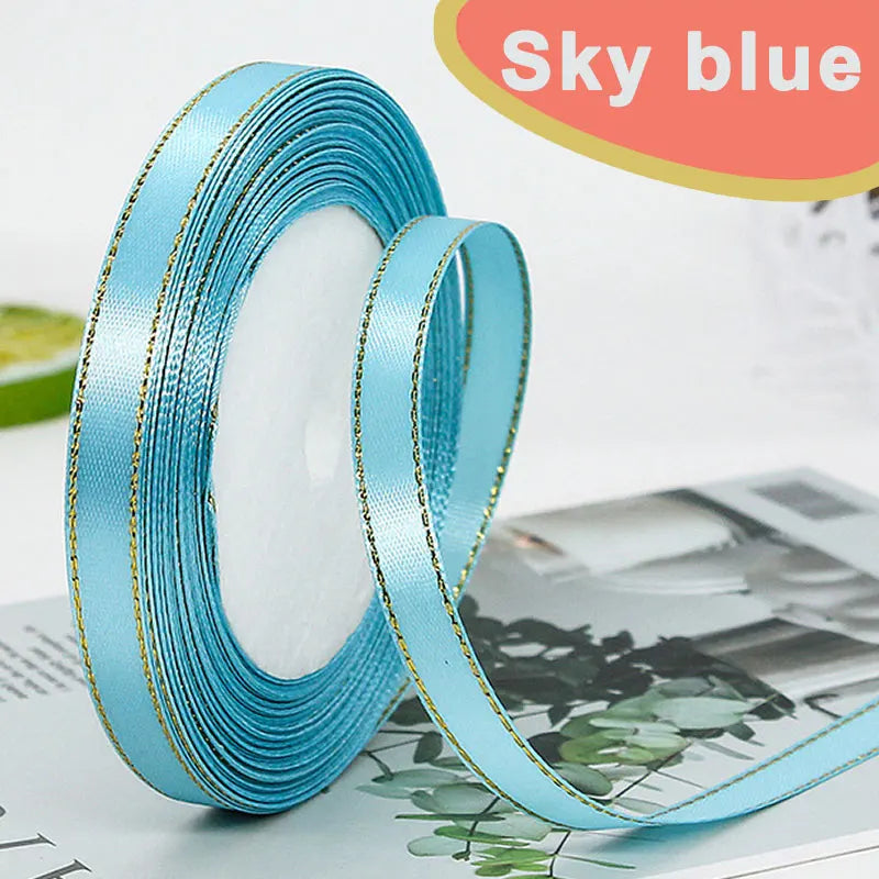 Roll of sky blue gold-edge satin ribbon for crafts and gift wrapping