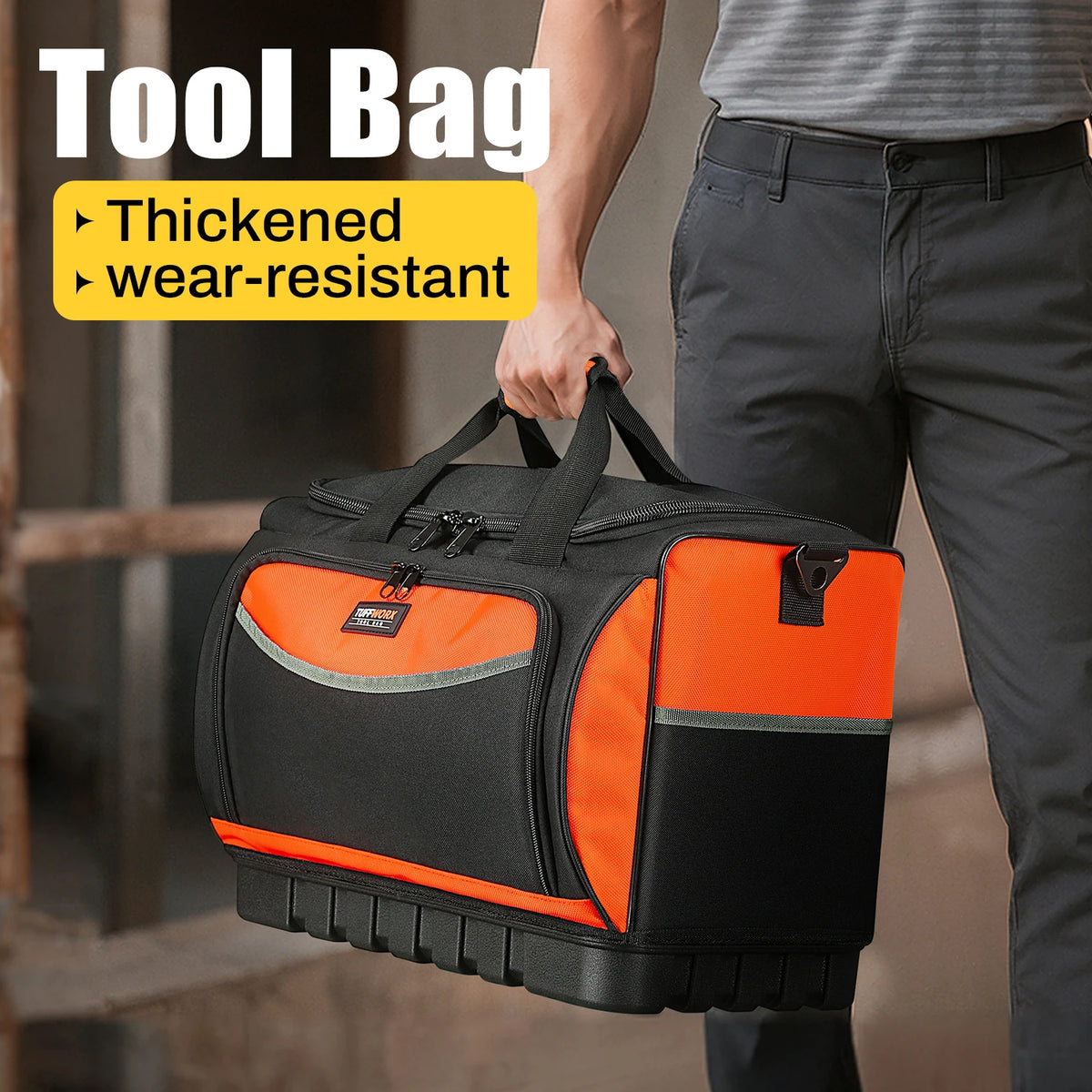 A person holds an orange and black tool bag with a molded base and multiple pockets.