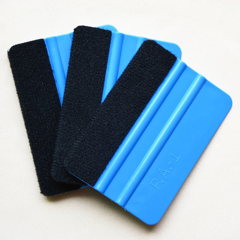 A set of three black suede felt squeegees with blue plastic handles for vinyl wrap and window tint installation.