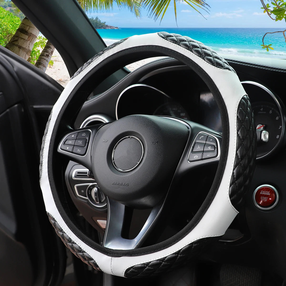 A close-up view of a black steering wheel with a white faux sheepskin cover, showing the interior and dashboard.
