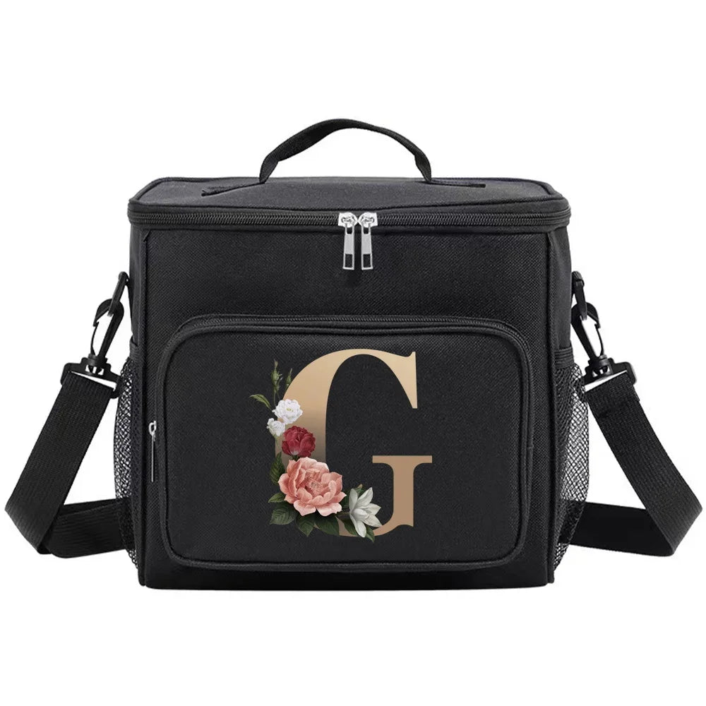 Black insulated canvas lunch bag with a gold initial G and adjustable straps