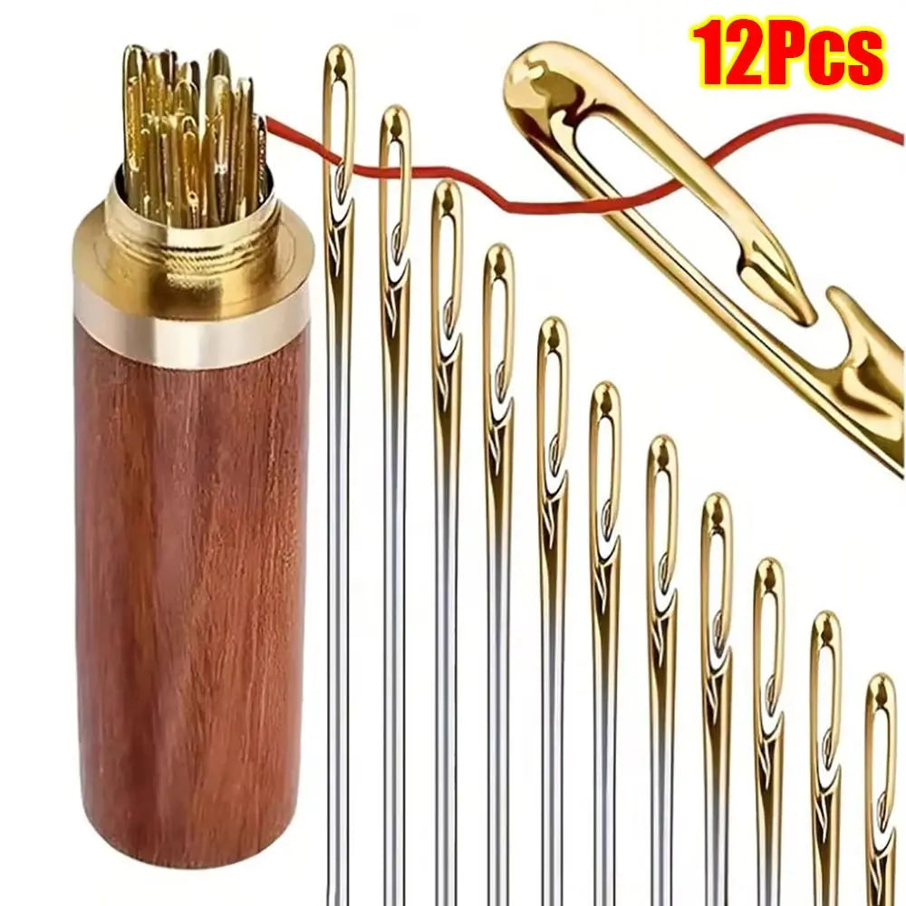 A set of 12 gold and silver self-threading sewing needles stored in a wooden container.