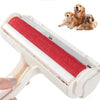 A white pet hair remover roller with a red textured pad is shown next to a golden retriever.